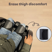 Person using a massage device on their thighs with text 'Erase thigh discomfort' on a beige background. | JC BUCKMAN IndulgeUs Full Body Massage Chair